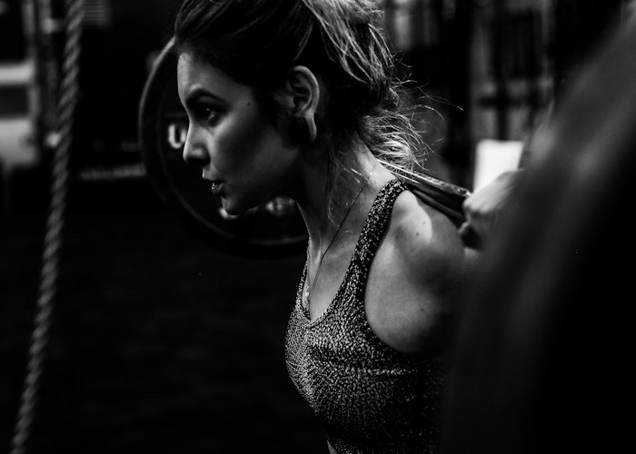 Weightlifter deadlifting a barbell in the gym